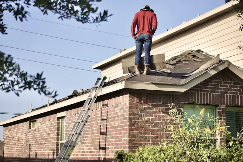 Professional roofer working on a residential roof in Smoketree